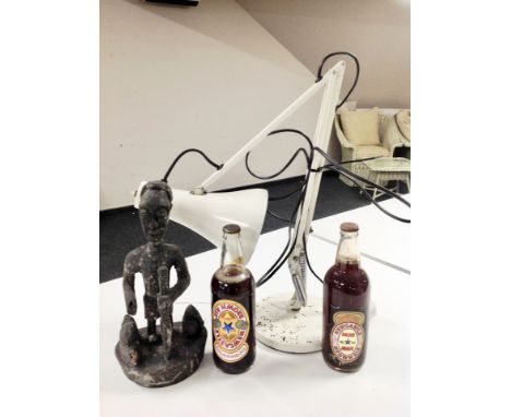 An anglepoise table lamp together with two bottles of Newcastle Brown ale 'Golden Jubilee' and a carved figure of an African 