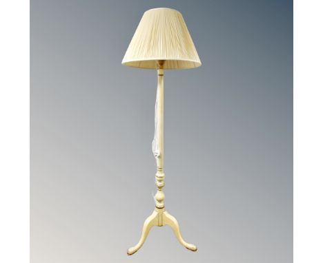 A painted standard lamp on tripod feet with shade 