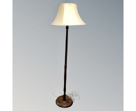 A beech wood standard lamp with shade 