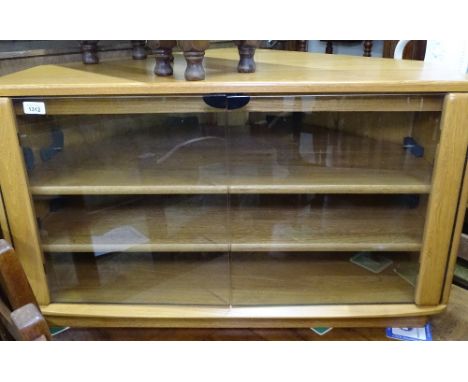 An Ercol elm corner TV stand, with 2 fitted shelves and glazed doors, W91cm, H55cm 