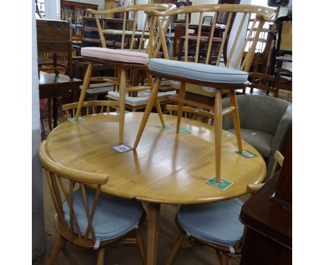 An Ercol elm and beech leg drop leaf dining table, together with a set of 4 matching stick-back chairs, and a pair of similar