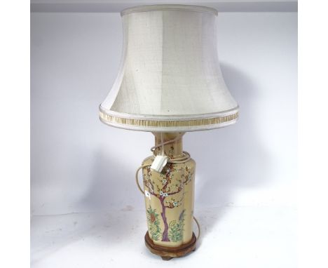 An Oriental ceramic table lamp with painted decoration, and shade, 74cm overall 