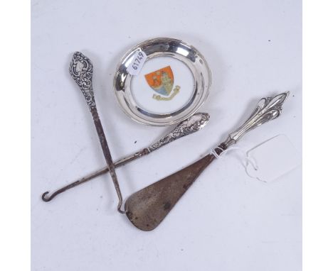 A crested pin dish with a silver mount, Birmingham 1906, silver-handled button hooks, and shoe horn 