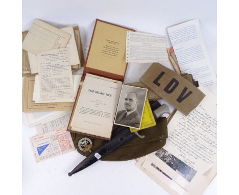 A Second World War Army cap, belt, LDV armband, knife in scabbard, various ephemera, and photographs 