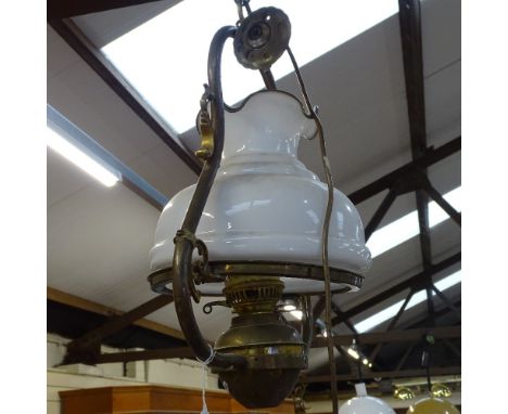 A brass hanging lantern light fitting, with opaque glass shade, height 46cm 