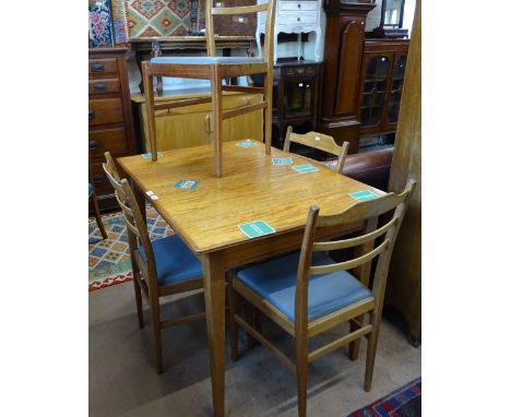 A Gordon Russell for Heals teak extending dining table (1 spare leaf), together with a set of 4 matching ladder-back chairs 