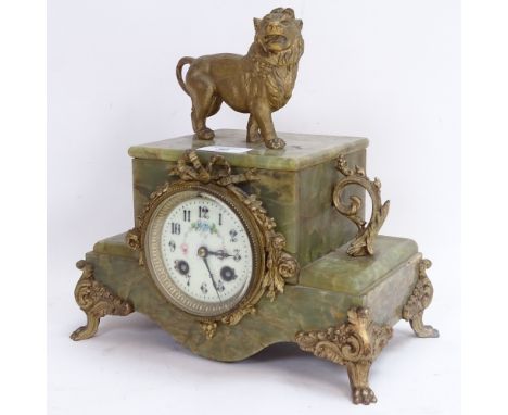 A French green onyx and gilt-brass 8-day mantel clock, cream enamel dial with Arabic numerals, lion paw feet surmounted by a 