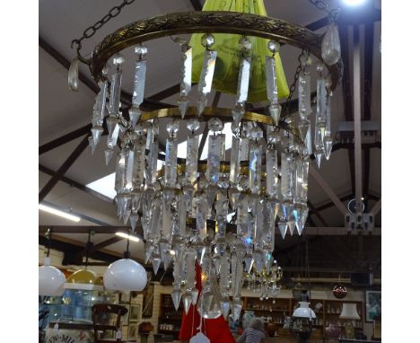 A large brass-framed 3-tier hanging light fitting, with tears of baguette-cut arrowhead glass lustre drops, together with som
