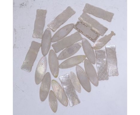 A group of mother-of-pearl gaming counters, largest length 6.5cm 