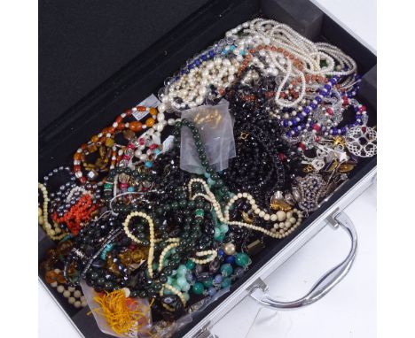 A case containing bead necklaces, including jade, coral etc 