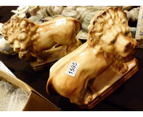 Pair of antique ceramic lion figures with glass eyes