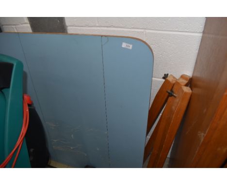 A vintage formica top kitchen table with drop leaves and detachable legs