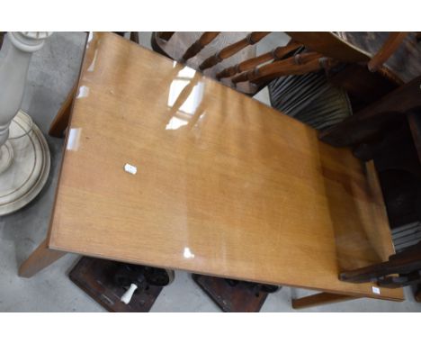 A vintage golden oak coffee table having glass protector top, approx. 110 x 53cm