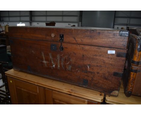 A traditional wooden bedding trunk having wrought iron handles