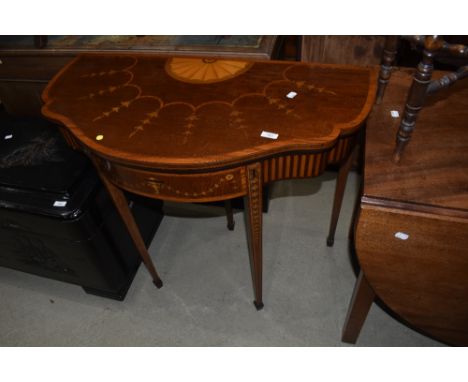 An Edwardian mahogany fold over card table having drawer leg, with shaped top and Sheraton revival style inlay decoration
App