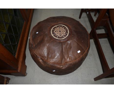 A vintage leather pouffe
Very scuffed and holes.&nbsp;