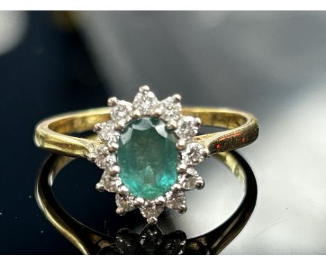9ct Gold ring set with central green stone, possibly emerald  surrounded by white stones Weight 3.7g Size R 