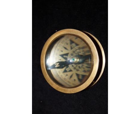 Brass compass with magnifying glass dome 
