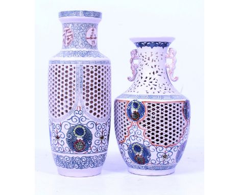 TWO 20TH CENTURY CERAMIC TABLE LAMP BASES with pierced honeycomb bodies and painted cartouches in Chinese style, with shaped 