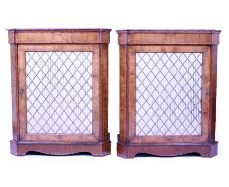 A PAIR OF MID VICTORIAN WALNUT AND CROSSBANDED PIER CABINETS with silk inlaid brass grill doors on bracket feet, 86cm wide x 