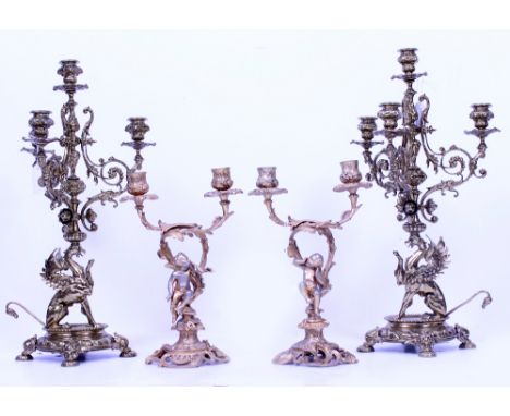 A PAIR OF GILT METAL FOUR BRANCH CANDELABRA each 52cm in height together with two Rococo style gilt metal twin branch candela
