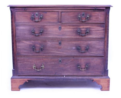 A GEORGIAN MAHOGANY CHEST OF TWO SHORT AND THREE LONG DRAWERS with a brushing slide and raised on bracket feet, 106cm wide x 
