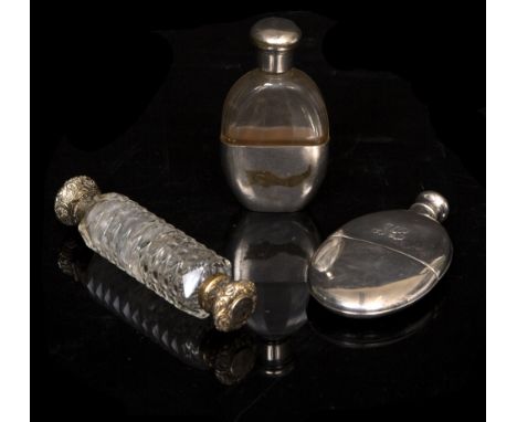 AN ANTIQUE SILVER OVAL HIP FLASK with detachable cup together with a glass hip flask with silver plated stopper and cup, and 