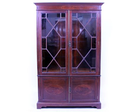 A GEORGIAN STYLE MAHOGANY BOOKCASE with twin astrigal glazed doors above two panel doors, raised on bracket feet 