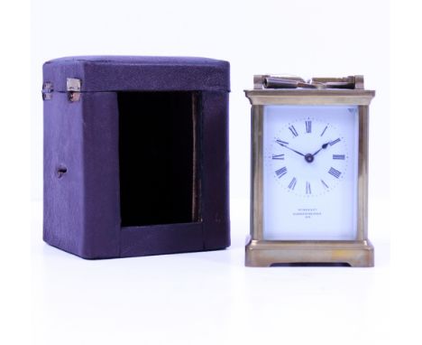 A LATE 19TH / EARLY 20TH CENTURY LEATHER CASED BRASS CARRIAGE CLOCK with white enamel dial and black Roman numerals 'Wynne &a