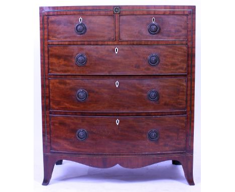 A 19TH CENTURY MAHOGANY BOW FRONTED CHEST of two short and three long drawers with brass ring necked handles and having brass