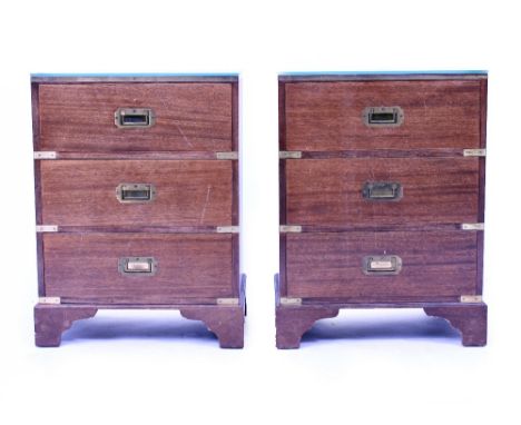 A PAIR OF MAHOGANY CAMPAIGN STYLE BEDSIDE CHESTS each with green leather inset tops having three drawers and brass inset hand