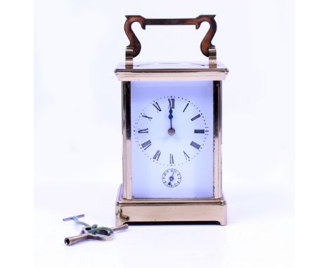 A LATE 19TH / EARLY 20TH CENTURY BRASS CASED CLOCK with white enamel dial and black Roman numerals with subsidiary dial with 