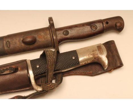 A GERMAN DRESS BAYONET, with 9 7/8" blade bearing Eickhorn twin squirrel mark, officer's knot, leather frog and metal scabbar