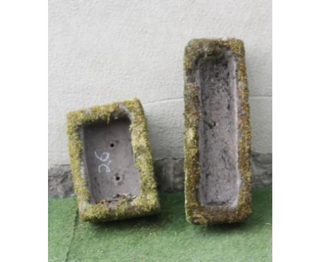 A SMALL SANDSTONE TROUGH of rough hewn oblong form, 21 1/2" x 15" x 11", together with a similar trough with sloping top, 34 