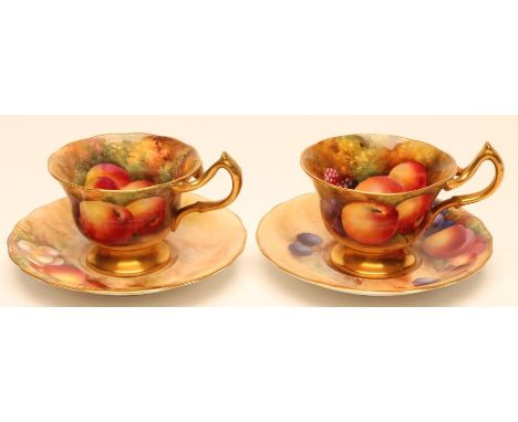 TWO ROYAL WORCESTER CHINA COFFEE CUPS AND SAUCERS, 1935, of lobed circular form with bi-furcated handles, variously painted i