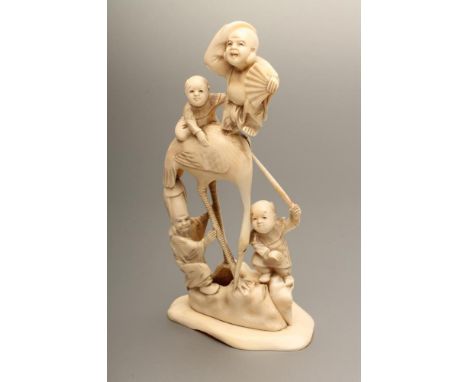 A JAPANESE IVORY FIGURE GROUP, Meiji period, carved as a large crane with two boys playing on its back, another at its feet w