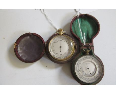 A VICTORIAN POCKET BAROMETER, the silvered two piece dial with curved thermometer, in gilded brass case, 2" wide, red leather