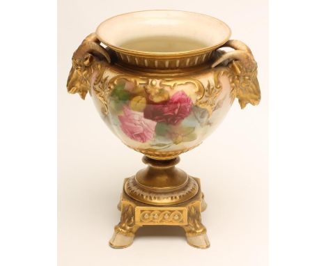 A ROYAL WORCESTER CHINA VASE, 1919, the baluster bowl with two ram's mask handles on a single blade knopped stem and canted s
