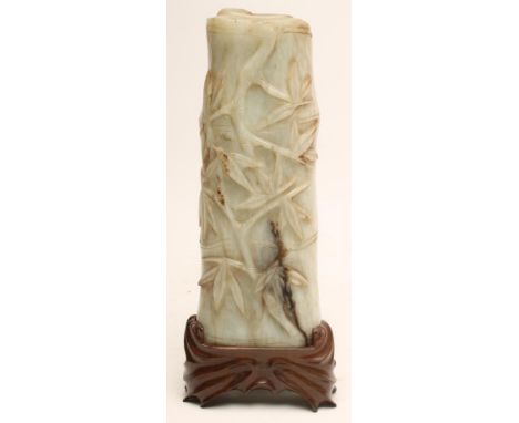 A JADE PANEL carved in relief with bamboo, 8 1/4" high, ensuite with matching hardwood easel stand (2) (Est. plus 21% premium