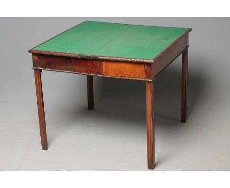 A GEORGIAN MAHOGANY CONCERTINA ACTION FOLDING CARD TABLE, mid 18th century, of oblong form, the foliate carved edged top open