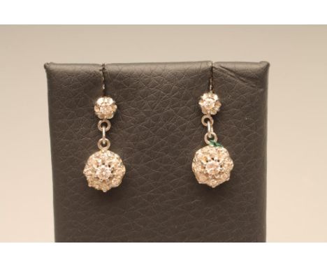 A PAIR OF DIAMOND DROP EAR STUDS, the central round brilliant cut stone claw set to an open border set with eight diamond poi