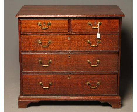 A GEORGIAN OAK CHEST, late 18th century, the moulded edged rounded oblong top over two short and three long cockbeaded drawer