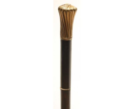 A SWORD STICK, early 20th century, with 13 1/4" fullered blade, bone joint buff, wrythen gilt metal knob and stained shaft, 3