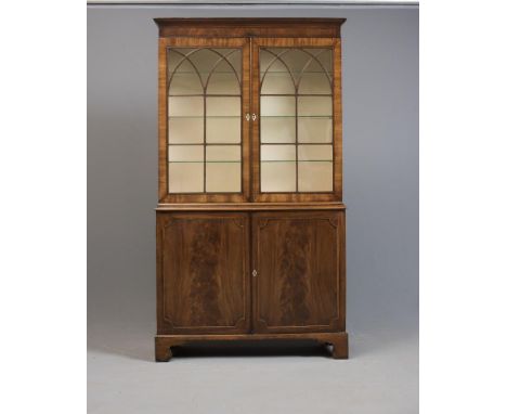 A GEORGIAN MAHOGANY TWO STAGE BOOKCASE, late 18th century and later, the cavetto moulded cornice and plain frieze over two do