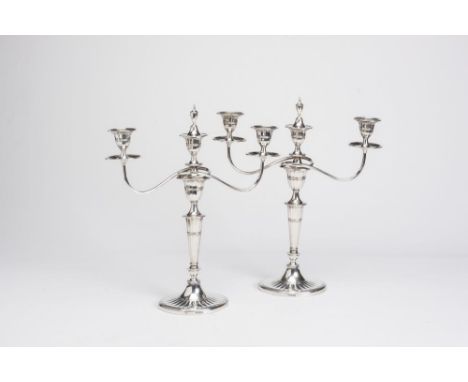 AN EDWARDIAN SILVER PAIR OF TWO BRANCH THREE LIGHT CANDELABRA, maker Thomas A. Scott, Sheffield 1910, the fluted tulip socket
