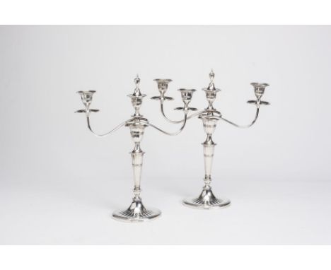 AN EDWARDIAN SILVER PAIR OF TWO BRANCH THREE LIGHT CANDELABRA, maker Thomas A. Scott, Sheffield 1910, the fluted tulip socket