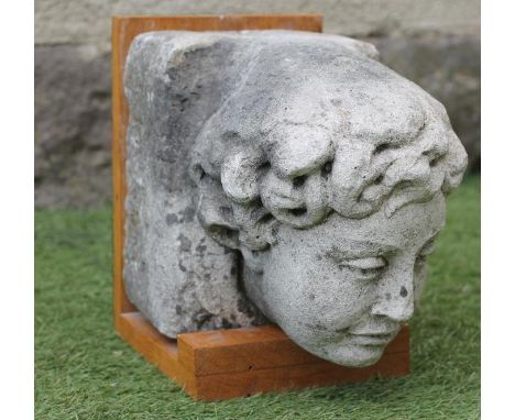A SANDSTONE FIGURAL CORBEL, c.1900, modelled as the head of a youth, 12 3/4" x 8 1/2", on oak bracket (Est. plus 21% premium 