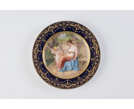 AN AUSTRIAN PORCELAIN CABINET PLATE, late 19th century, centrally painted in polychrome enamels with Cupid aiming his arrow a