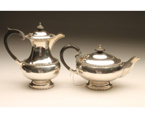 A SILVER TEAPOT AND COFFEE POT, maker Walker & Hall, Sheffield 1950, of baluster form with cast reel and bobbin rims, the hin