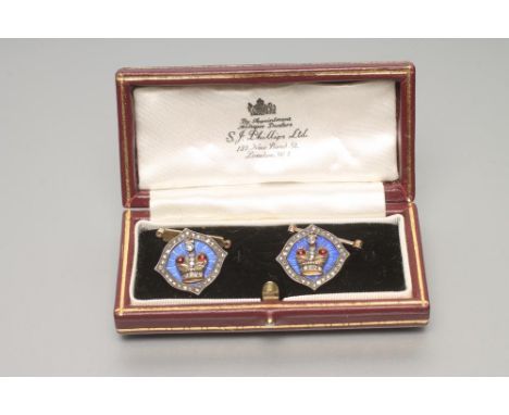 A PAIR OF CUFFLINKS, with a crown motif, overlaid in blue guilloche enamel set with a border of rose cut diamonds linked to e